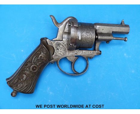 A six shot hammer action pin fire revolver with heavy engraving to the cylinder side plate and 2.25" octagonal barrel and orn