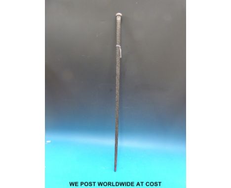 A carved Anglo Indian stick with white metal top 