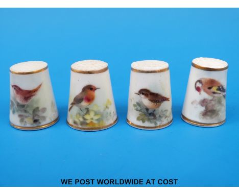Four Royal Worcester thimbles hand decorated with birds, all signed Powell and with puce marks (tallest 2.5 cm)
