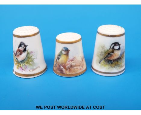 Three Royal Worcester thimbles hand decorated with birds, two signed Barber, the other Stinton, all with puce marks (tallest 