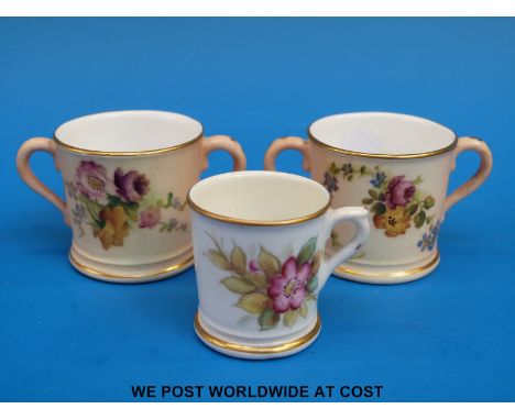 Two Royal Worcester blush ivory loving mugs decorated with flowers together with a miniature Royal Worcester mug painted with