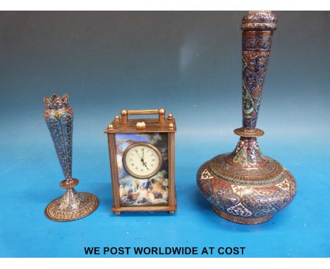 A small carriage clock decorated with classical scenes and two middle eastern cloisonné vases