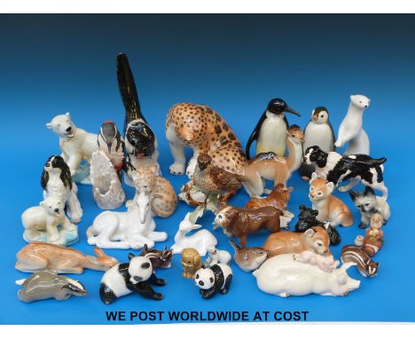 A large collection of ceramic animals to include a Beswick pig and panda, Doulton, Lomonosov/USSR, Goebel, Wade etc