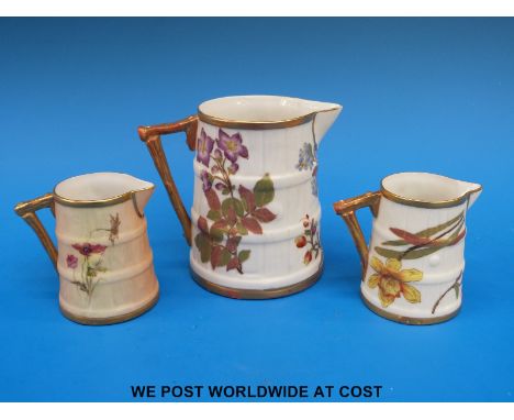 Two Royal Worcester barrel shaped jugs hand painted with flowers (6cm tall) together with another similar Royal Worcester jug