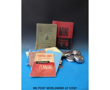 Four knock on spinners complete with spanner together with a collection of car manuals etc to include Morris, Vauxhall, Austi