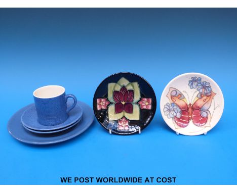 A small Moorcroft pin dish decorated with a butterfly and another with an abstract violet design (both 12cm diameter)  and a 