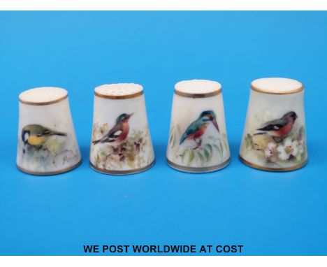 Four Royal Worcester thimbles hand decorated with birds, all signed Powell and with puce marks (tallest 2.5 cm)
