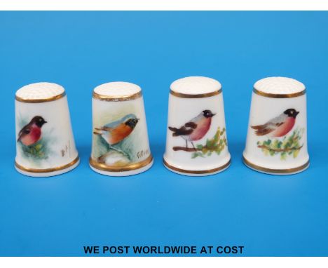 Four signed Royal Worcester thimbles hand decorated with birds, all with black stamps (tallest 2.5cm)