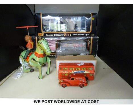 Six diecast model vehicles together with a clock work car and a clockwork horse, some in original boxes 