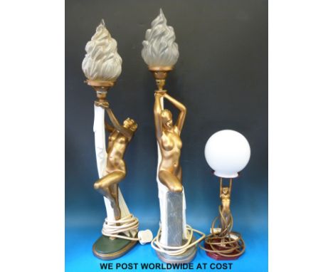 Two Art Deco style lamps formed as nudes holding flaming globes aloft (height of each 76cm)
together with a further similar s