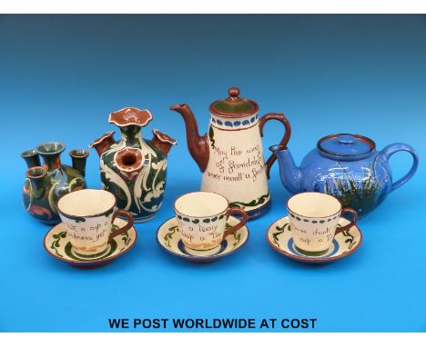 A collection of Aller Vale, Exeter and Torquay pottery including two puzzle jugs and a teapot