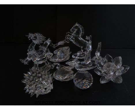 Nine Swarovski crystal ornaments including a dragon, hedgehog, ship, flower, rocking horse etc, some in original boxes 