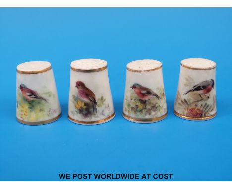 Four Royal Worcester thimbles hand decorated with birds, all signed Powell and with puce marks (tallest 2.5 cm)