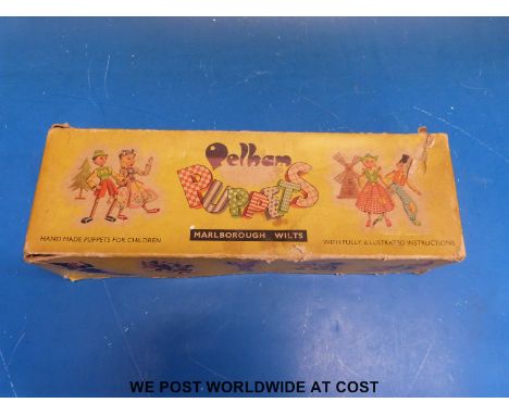 A Pelham poodle puppet in box