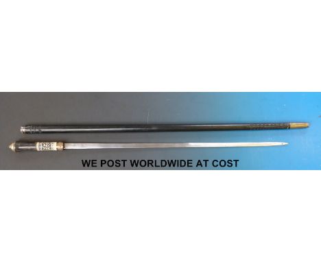An Eastern sword stick with carved ebony shaft, brass banding, horn handle and carved bone decoration, blade marked India (le