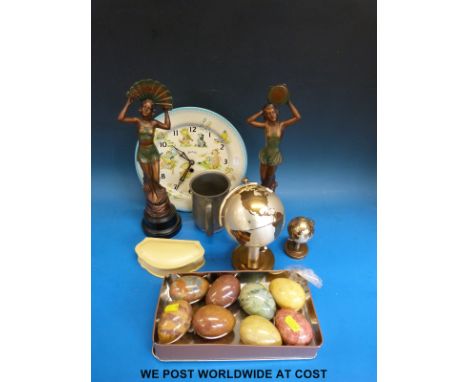 A collection of alabaster eggs, a globe cigarette lighter and matching holder, pair of spelter statues, pewter mug and a chil