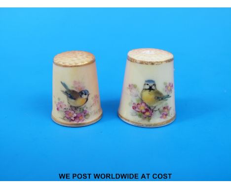 Two Royal Worcester thimbles hand decorated with birds, both signed Powell, unmarked (tallest 2.5cm)