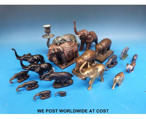 A collection of brass and other metal elephants to include a pair of cast bronze elephants and a verdigris bronze elephant wi