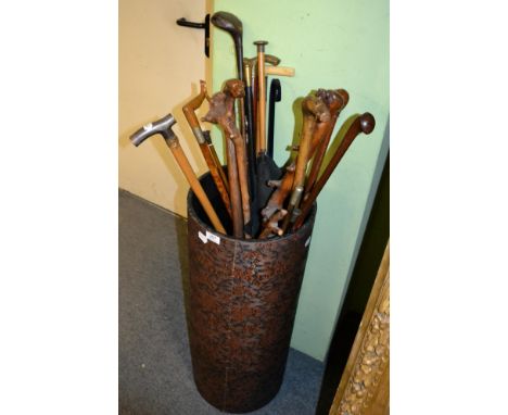 A quantity of sticks, canes and parasols including dog carved handles, etc (in a stick stand)