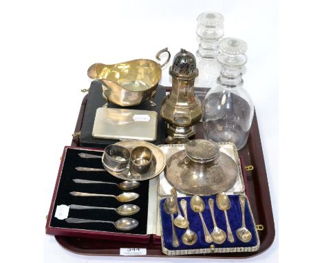 A group of silver including a sauce boat, a cigarette box, a dish, two napkin rings, a capstan inkwell, a sugar caster, two s