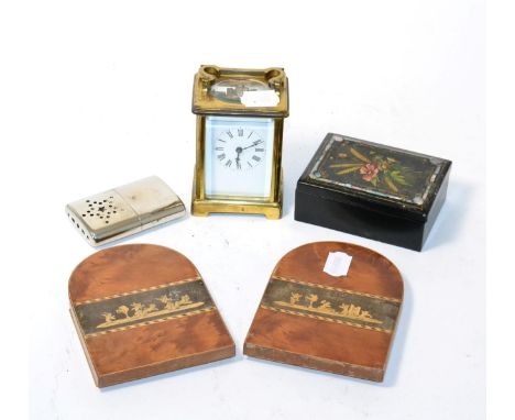 A brass carriage clock, papier mache box and a pair of bookends 