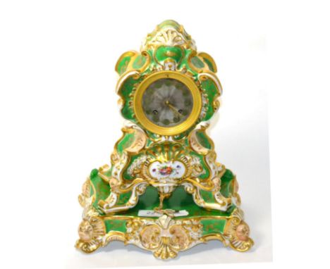 A green porcelain and floral decorated striking mantel clock, raised upon a matching porcelain stand 