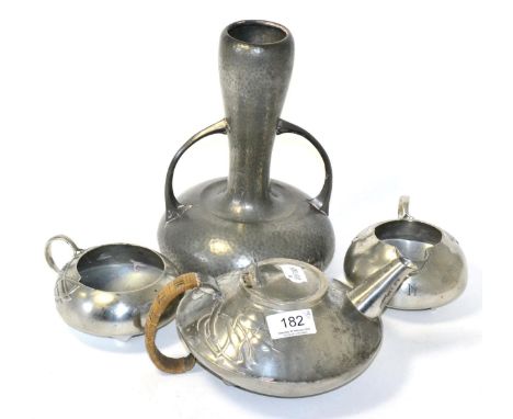 Three piece tea service designed by Archibald Knox and a pewter vase All three items in tea set are monogrammed 'N'. Teapot w