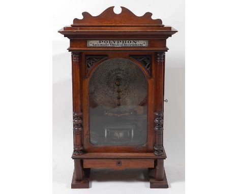 A late 19th century walnut cased free standing and coin operated Polyphon by Nicole Freres of Leipzig, playing 15 1/2" discs,