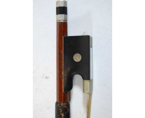 A German nickel mounted violin bow having an ebony frog with mother of pearl eye, stamped W. Seifert, 61cm., together with va