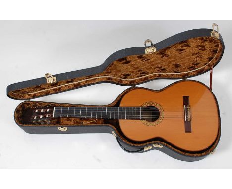 A Taurus Spanish nylon strung acoustic guitar, the carved rosewood headstock with pearloid machine heads, the nineteen fret n