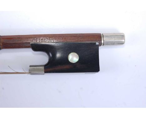 A late 19th century German violin bow, having nickel mounts and mother of pearl inlaid frog, 74cm, together with eight other 