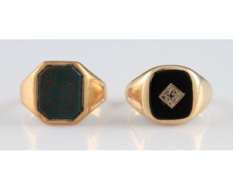 A 9ct yellow gold signet ring, set with a rounded rectangular black hard stone inset with a round cut diamond, with tapered s