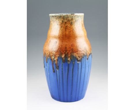 A Ruskin pottery vase of waisted form with a matt drip glaze body having teal and orange coloured upper body with blue colour