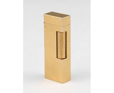 A Dunhill gold plated lighter with machined grid design body, bears makers marks, length 6.5cm.