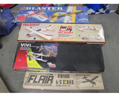 FOUR BOXED R/C MODEL AIRCRAFT SETS COMPRISING A FLAIR BLACK MAGIC SET, A PRECEDENT FUN FLY, A VIVI FREESTYLE AEROBATIC MODEL,