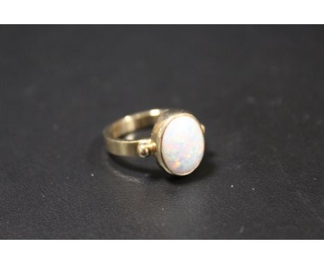 A HALLMARKED 9CT GOLD OPAL SET DRESS RING, opal within a rub over mount approx W 10 cm,  H 12 mm, ring size M                