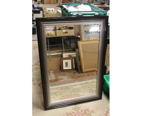 A MODERN BEVEL EDGED MIRROR 104 X 73 CM
