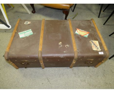 A LARGE VINTAGE BANDED PACKING TRUNK WITH VARIOUS STICKERS TO INCLUDE A NORTHERN STAR EXAMPLE 