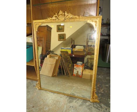 AN ANTIQUE GILT OVERMANTEL MIRROR WITH CARVED DETAIL H-140 W-1216 CM