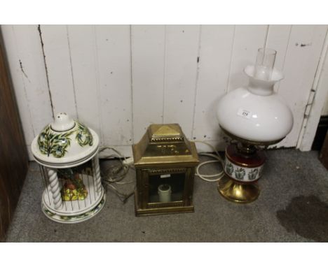 A CONVERTED OIL LAMP WITH CERAMIC FONT, TOGETHER WITH A  MODERN CERAMIC TABLE LAMP AND A REPRODUCTION VICTORIAN CANDLE LANTER