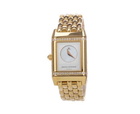 LADY'S JAEGER LE COULTRE REVERSO EIGHTEEN CARAT GOLD QUARTZ WRIST WATCH,one dial with mother of pearl centre and diamond bord