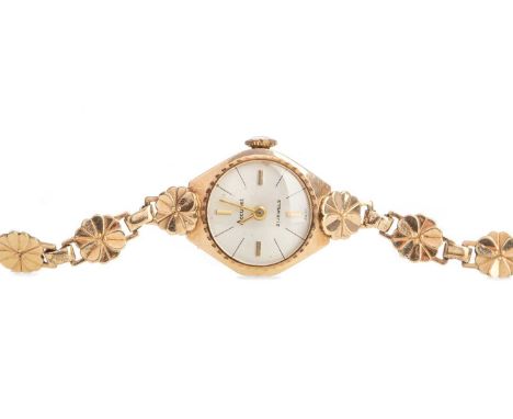 LADY'S ACCURIST NINE CARAT GOLD MANUAL WIND WRIST WATCH,the round silvered dial with baton hour markers, 17mm case, on a flor