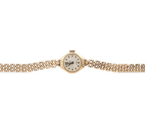 LADY'S DELMA NINE CARAT GOLD MANUAL WIND WRIST WATCH,the round silvered dial with applied baton hour markers, 16mm case, on a