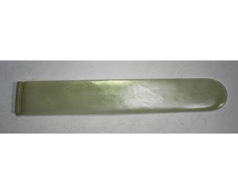 A Chinese pale celadon jade page turner, late Qing dynasty/20th century, carved with scroll end, length 19.2cm.Buyer’s Premiu