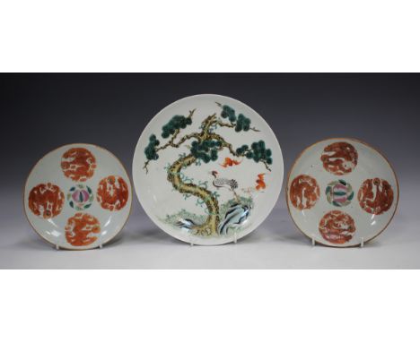 A Chinese porcelain saucer dish, mark of Tongzhi but later, painted with a red capped crane and two bats beneath a pine tree,