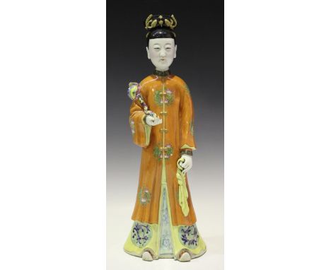 A Chinese famille rose porcelain figure, modelled standing wearing a long orange robe, impressed seal mark to base, height 41