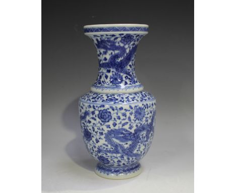 A Chinese blue and white porcelain vase, mark of Qianlong but probably 20th century, painted with dragons amidst peony, under