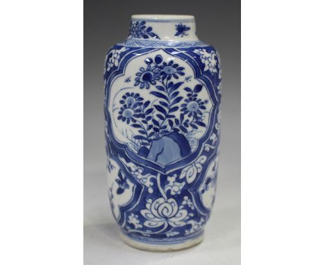 A Chinese blue and white porcelain vase, Kangxi period, of swollen cylindrical form, painted with panels of flowers and bloss