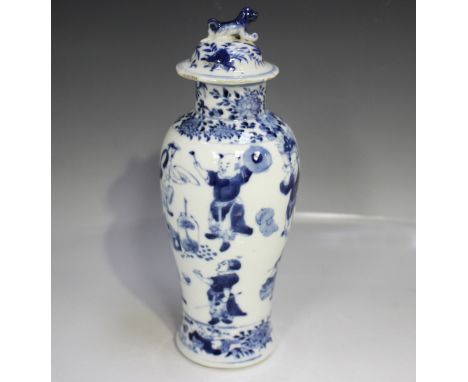 A Chinese blue and white porcelain vase and cover, mark of Kangxi but late 19th/early 20th century, the slender baluster body