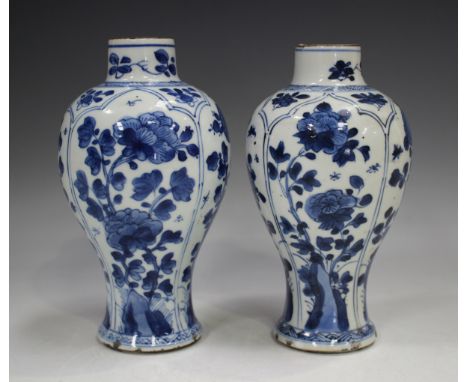 A near pair of Chinese blue and white porcelain vases, Kangxi period, each baluster body painted with four vertical arched pa